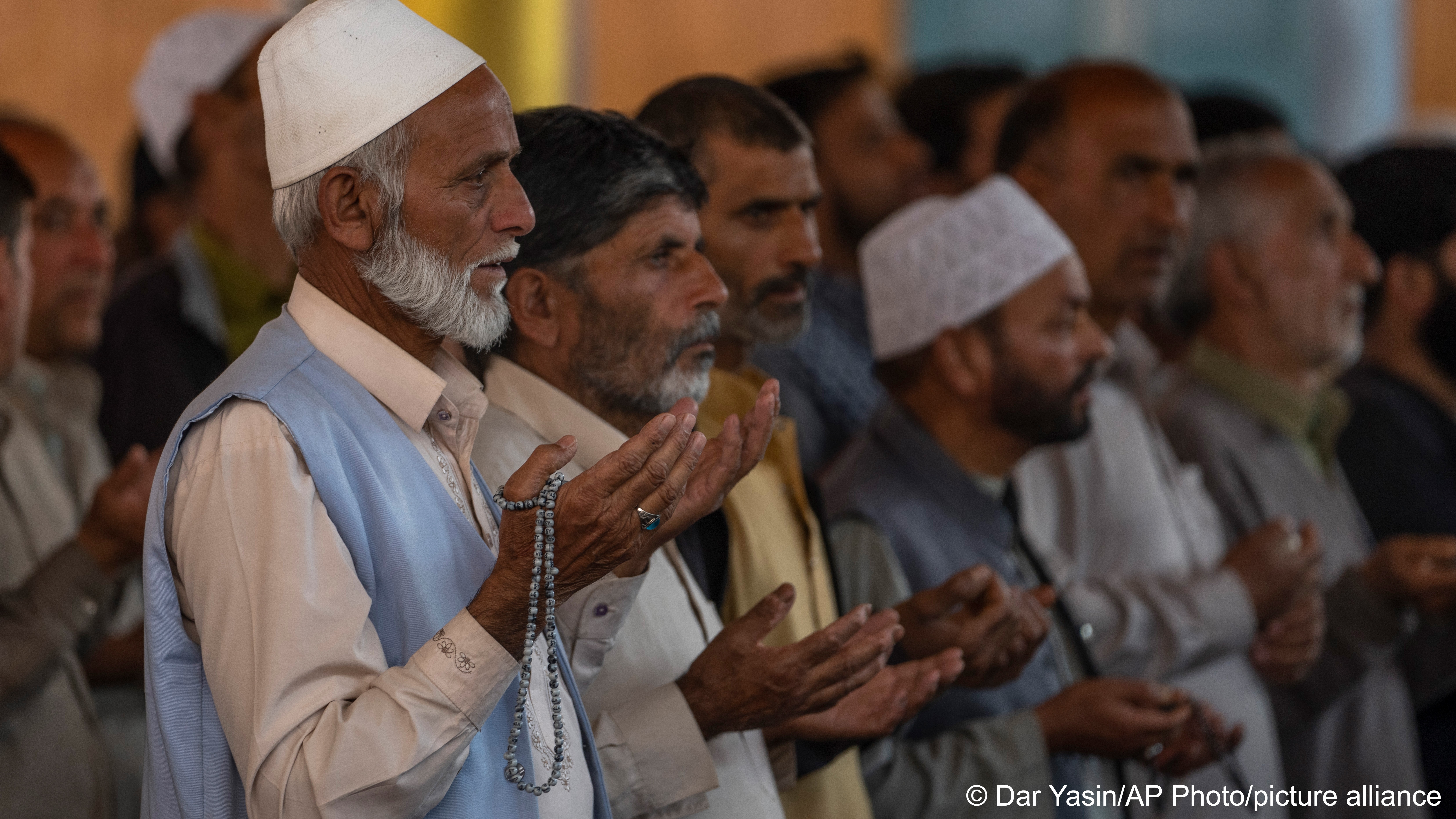 A group of Kashmiri Muslim men attending Friday prayers