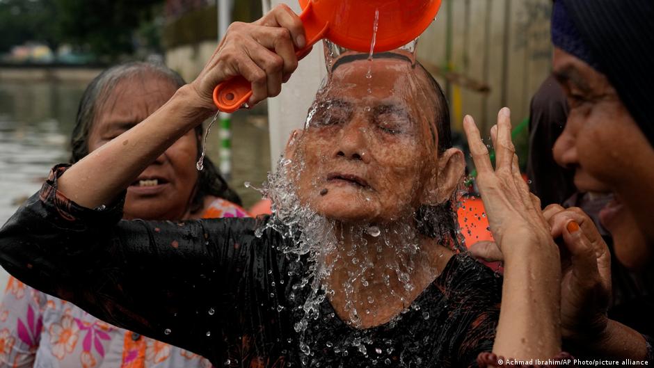 A group of Indonesian women in Tangerang follow the local tradition of washing themselves in the Cisadane River before Ramadan