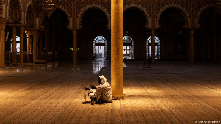 A devout Senegalese man sits in silence on the eve of Ramadan, in an almost deserted mosque