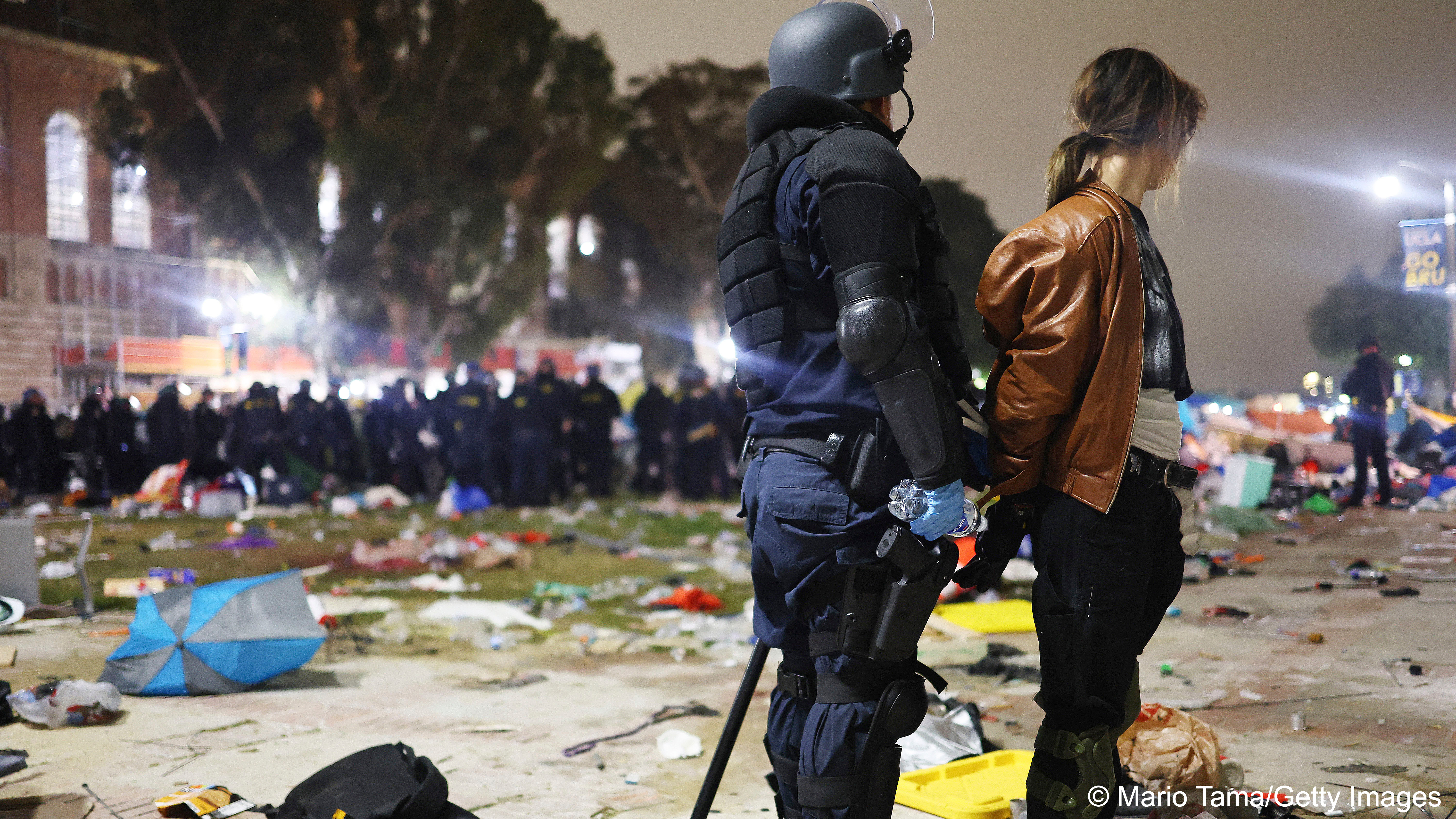 A California Highway Patrol (CHP) officer detains a protestor while clearing a pro-Palestinian camp after dispersal orders were given at UCLA campus, Los Angeles, USA, 2 May 2024