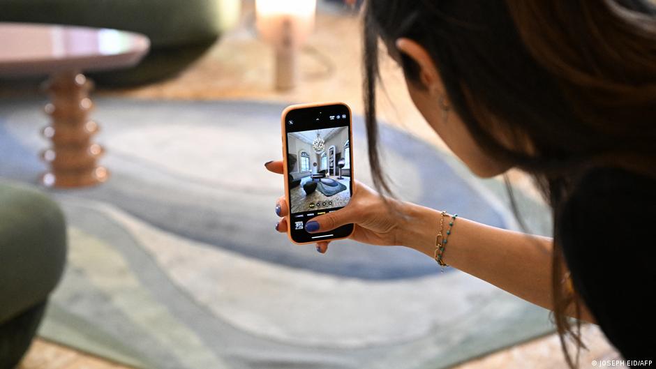 A visitor snaps a picture of furniture designed in Lebanon