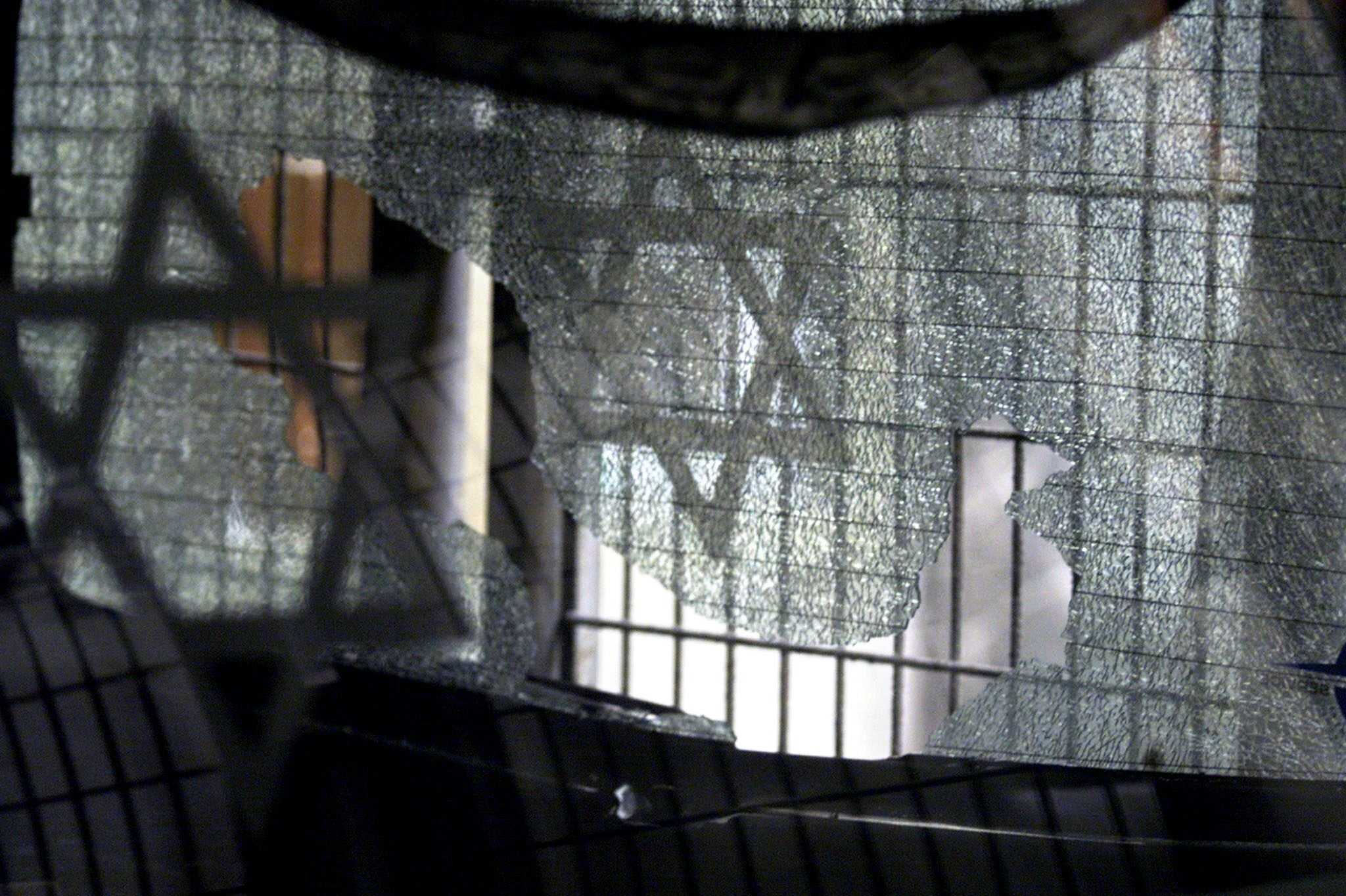 A broken pane of glass with the Jewish star after an attack on a synagogue in Istanbul