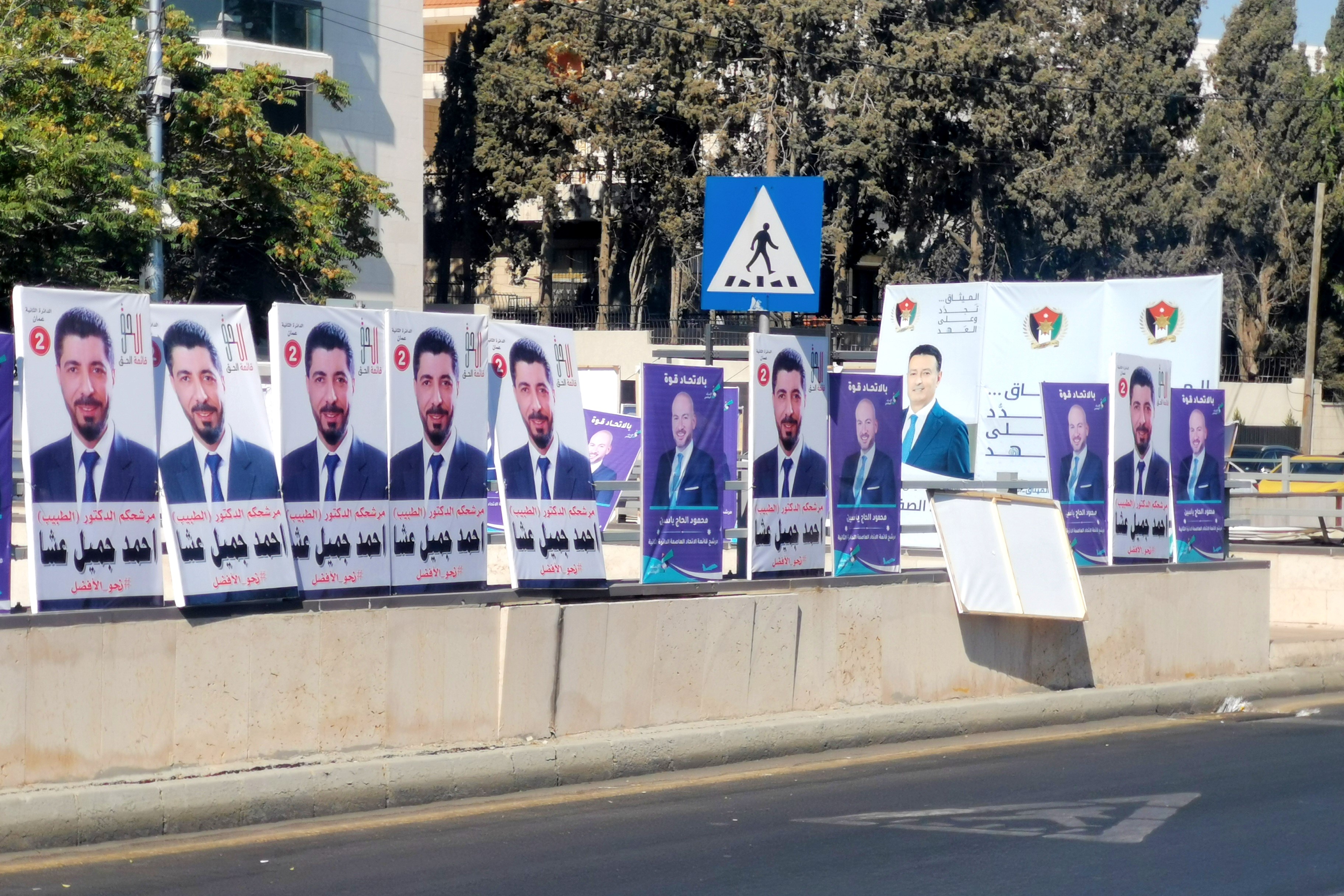 Many copies of the same election poster on a bridge in Amman.