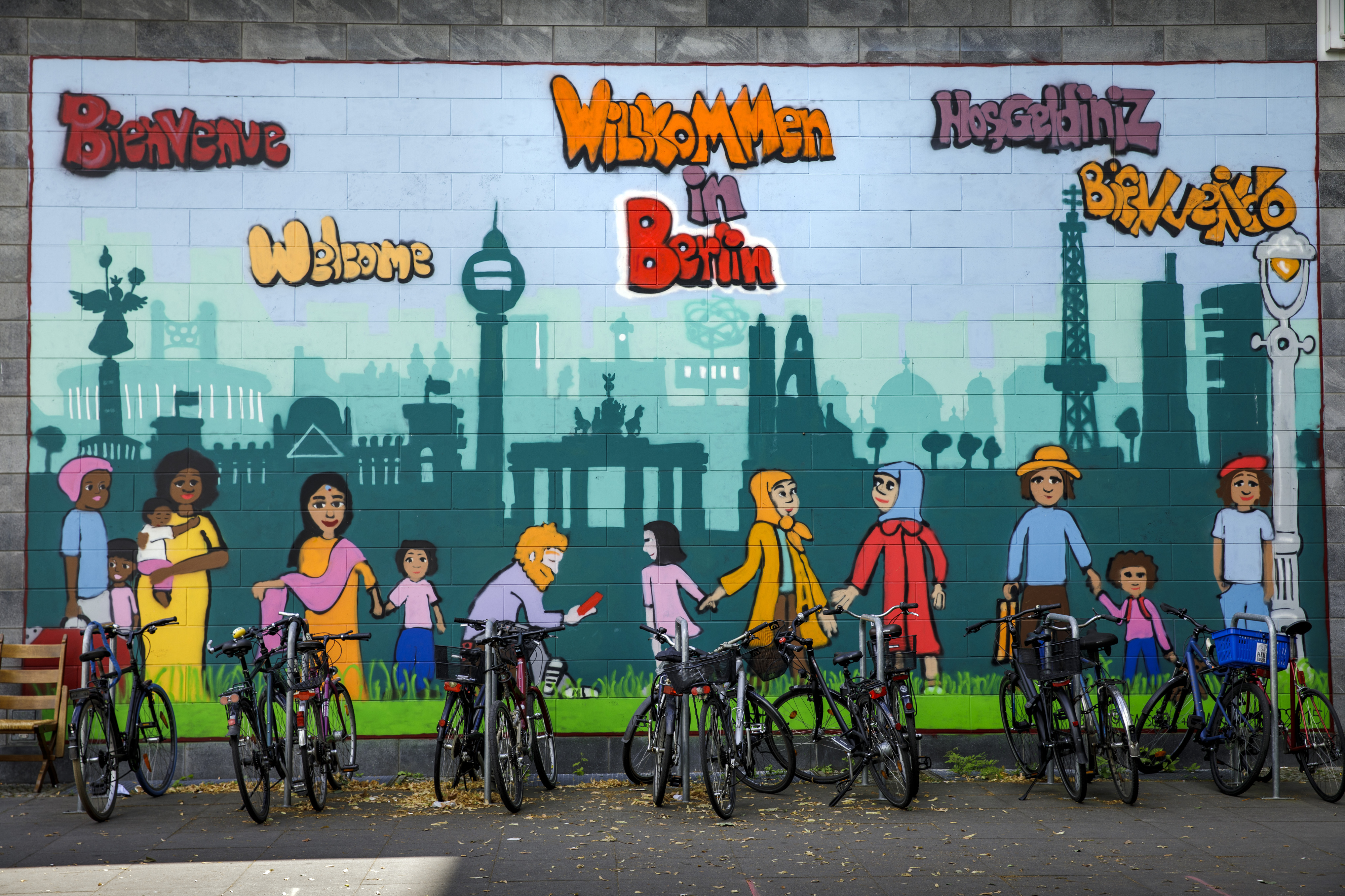 A wall of graffiti welcoming tourists and immigrants to Berlin