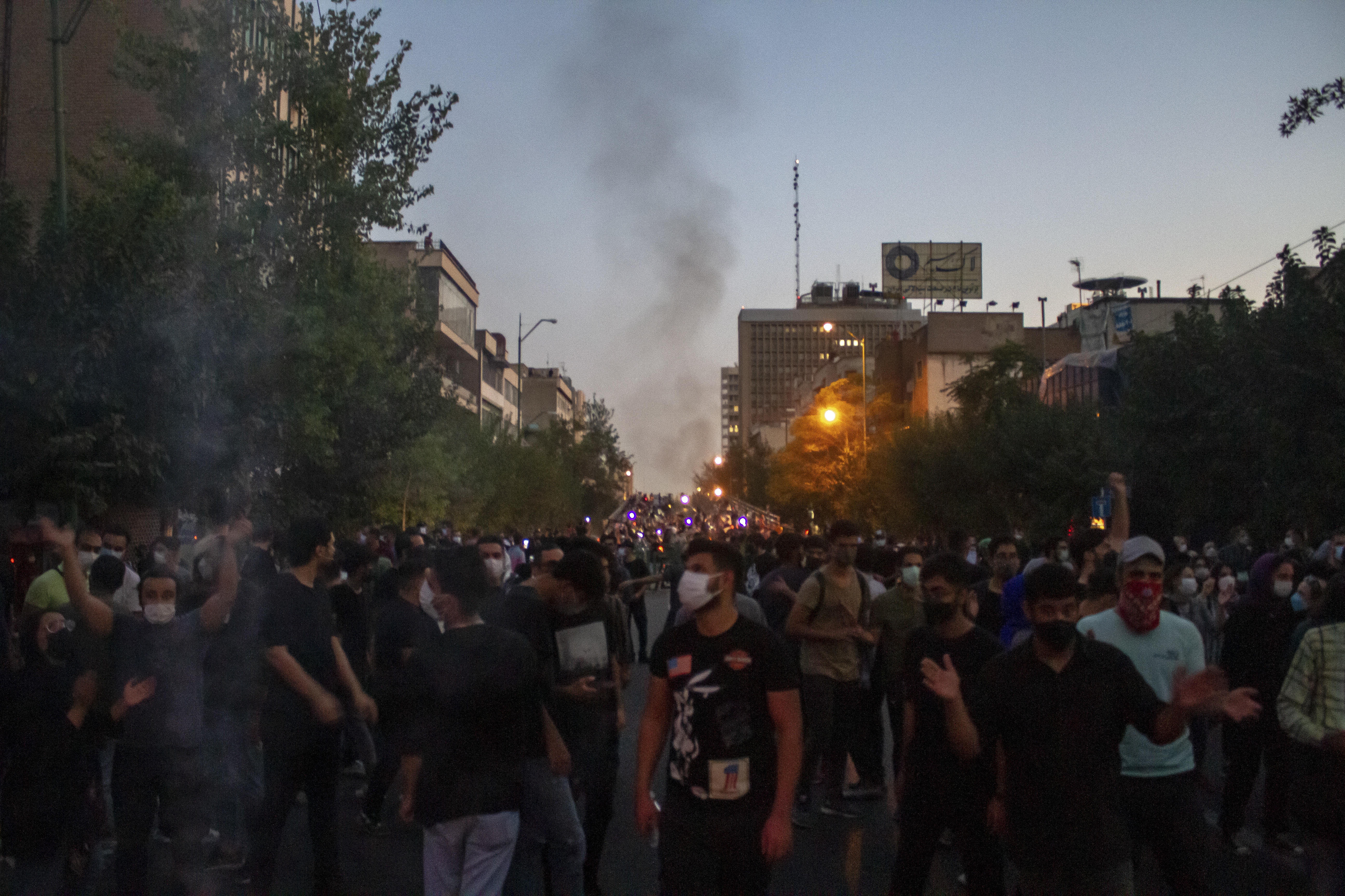 A crowd assembles at dusk in Tehran.