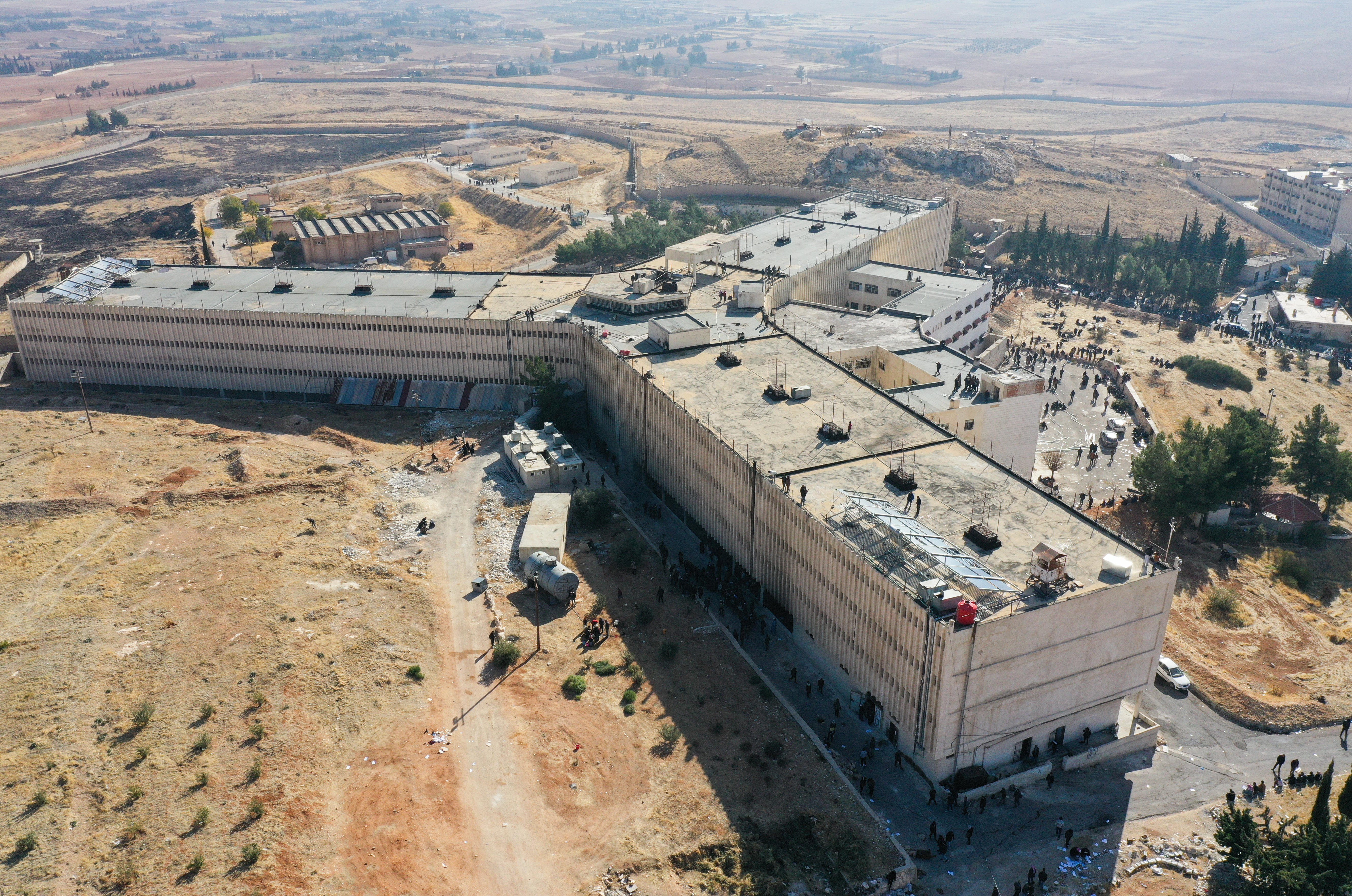 Birds-eye view of a large, star shaped concrete building made from three wings.