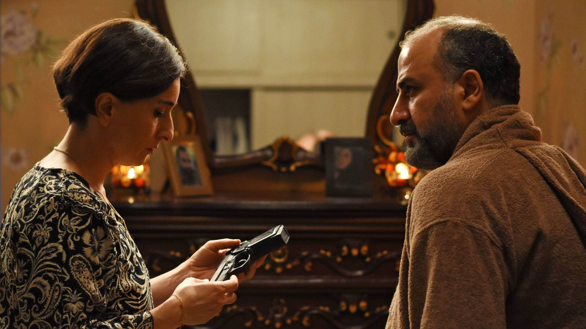 A man and a woman sitting opposite each other, taken from the side.