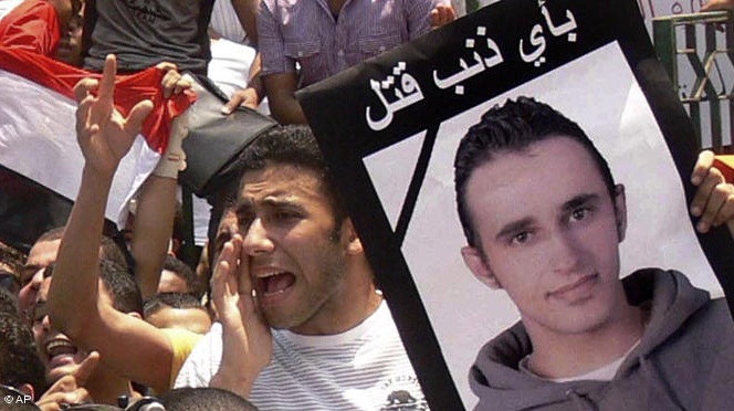  Egyptian demonstrators on Tahrir Square with a placard bearing the image of Khaled Said, the young man beaten to death by police