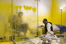 Wafaa Bilal and a visitor behind a glass shield (photo: Wafaa Bilal)