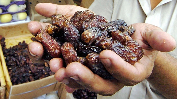 A Bangladeshi street vendor presents some dates (photo: Farjana K. Godhuly/AFP/Getty Images)