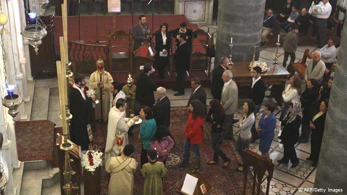 Syrian Christians take communion during Sunday service at the Greek Catholic Church of Our Lady Al-Niyah in Damascus on May 01, 2011, as the Syrian government cracks down on protesters across the country calling for a change of regime (photo: Louai Beshara/AFP/Getty Images) 