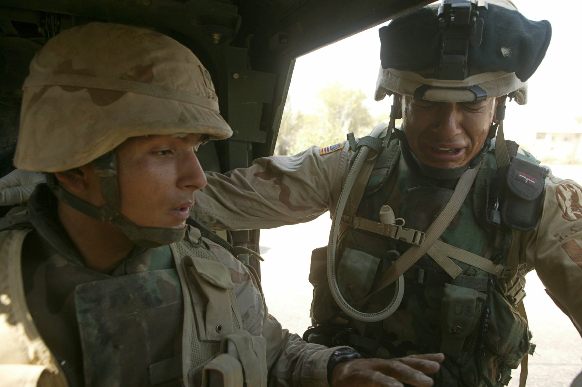 Two brothers break down in tears following a roadside bomb attack, 5 June 2004, Sadr City, Baghdad, Iraq (photo: Michael Kamber)