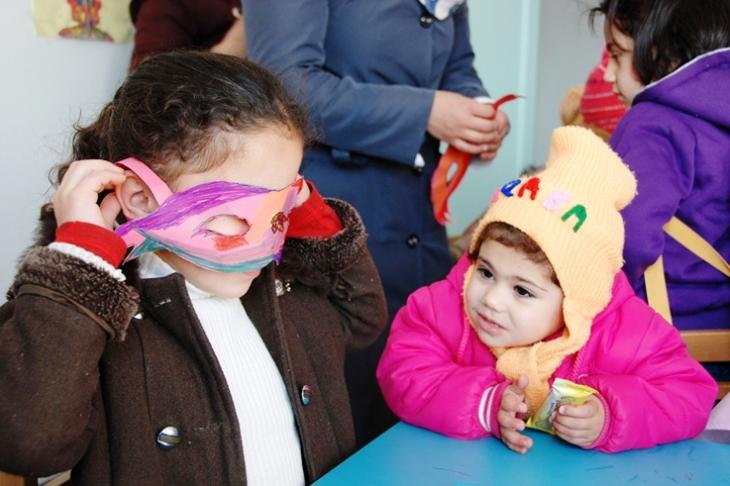 Children making paper masks in a kindergarten in Manshia, Jordan (photo: Laura Overmeyer)