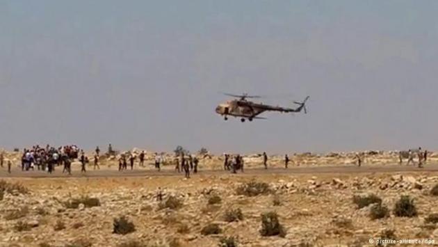 Refugees run towards an approaching Iraqi helicopter (photo: picture-alliance/dpa)