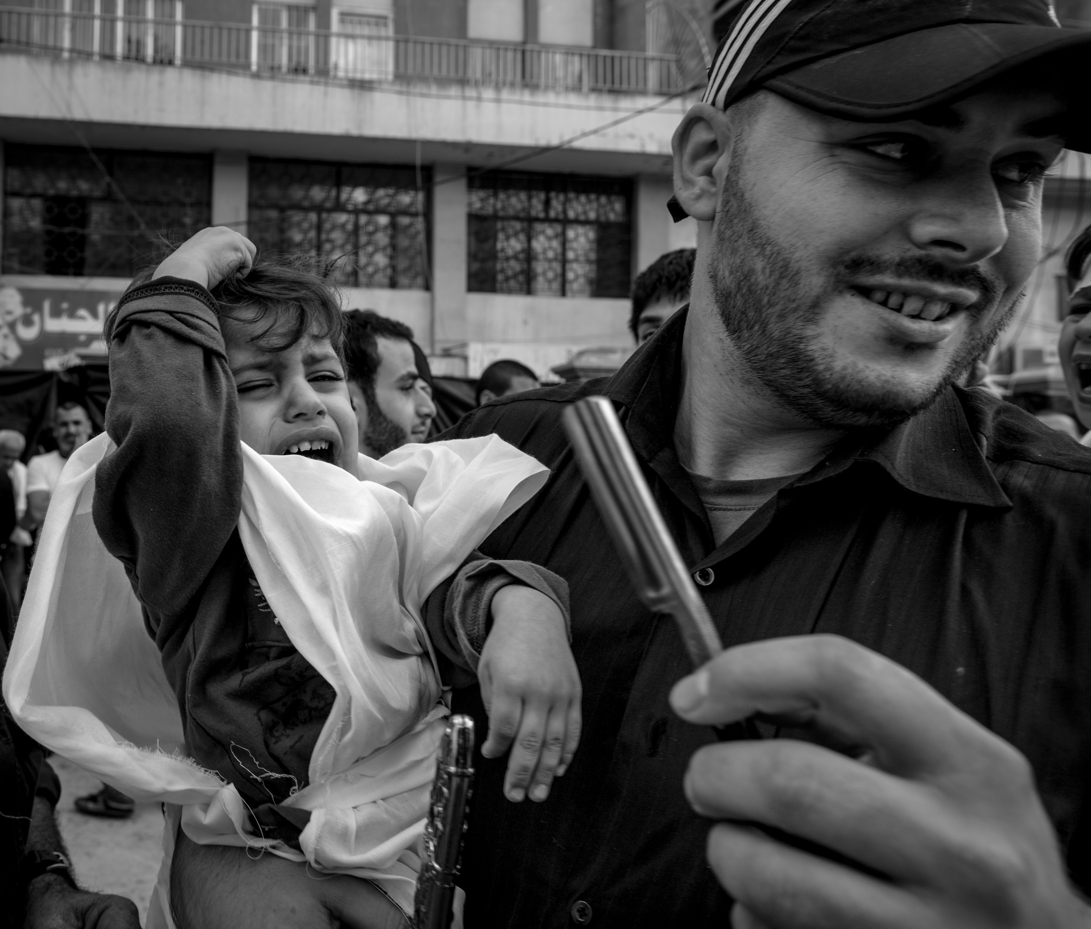 A child wails, not wanting to have its forehead cut, Nabatiyeh, Lebanon, November 2014 (photo: Maya Hautefeuille)