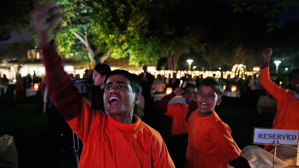 Rescued child labourers from the Save the Childhood Movement at the Norwegian embassy in New Delhi cheer as founder of the organisation, Kailash Satyarthi, receives the Nobel Peace Prize, 10 December 2014 (picture-alliance/AP Photo/M. Swarup)