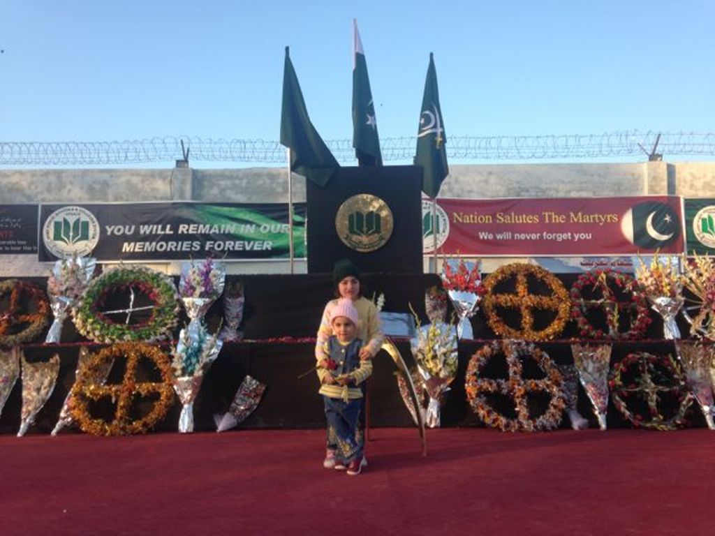 Two young girls stand in front of the memorial at the Army Public School in Peshawar, Pakistan (photo: Kiran Nazish)