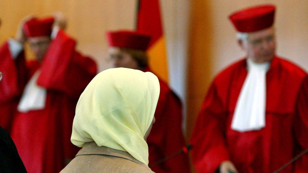 Fereshta Ludin, muslimische Lehrerin und Beschwerdeführerin im Kopftuch-Streit, sitzt am 24.09.2003 nach der Urteilsverkündung im Bundesverfassungsgericht in Karlsruhe vor den Richtern; Foto: picture-alliance/dpa/U. Deck