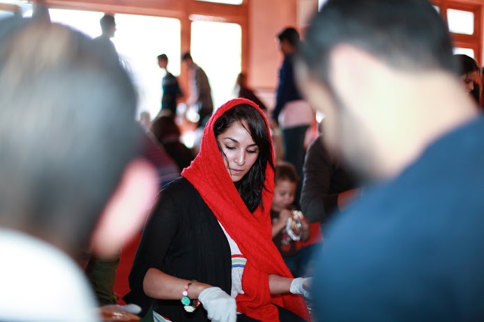 A young Muslim woman making bag lunches for homeless people (photo: Abdel-Rahman Bassa)