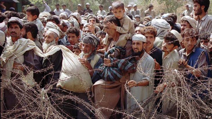 Afghan refugees behind a barbed wire fence at the border with Pakistan (photo: AP)