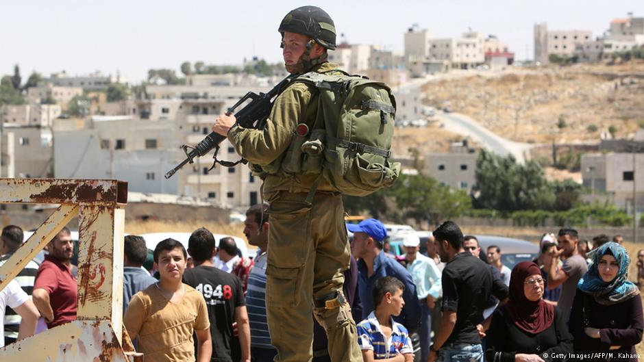 Israeli soldier guarding a checkpoint south of Hebron