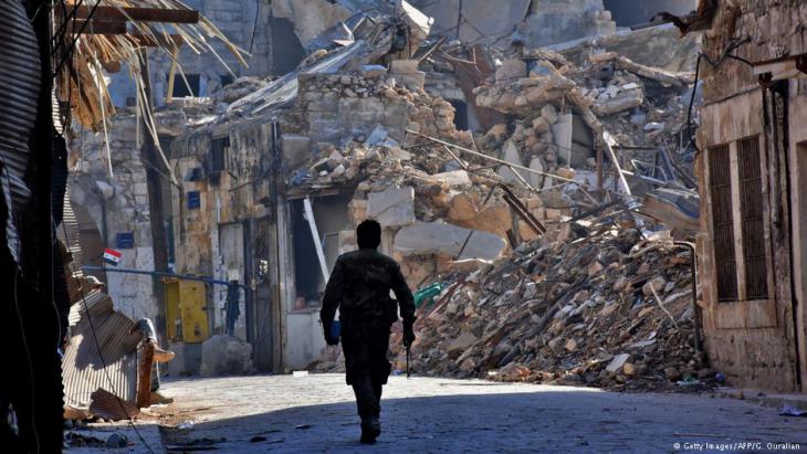 Pro-Assad fighter in the rubble of Aleppo (photo: AFP/Getty Images)