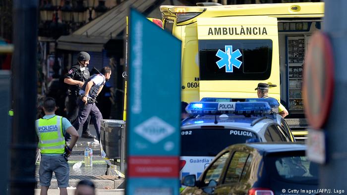 A yellow ambulance and a police car in the street