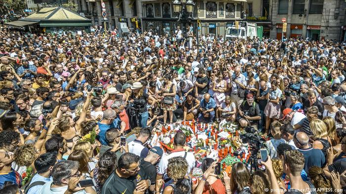 A crowd of people stand in Las Ramblas