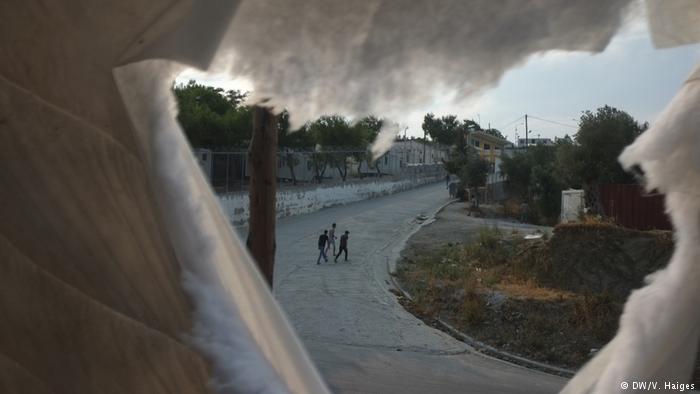 Moria refugee camp seen through a makeshift shelter