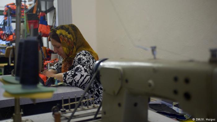 A woman works away at a sewing-machine