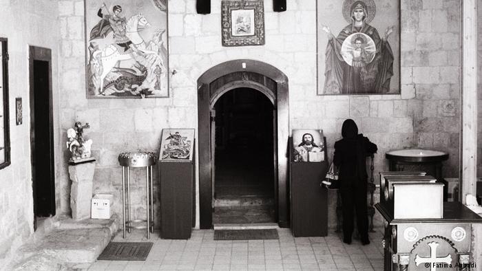 A woman in St. George's Church (photo: Fatima Abbadi)