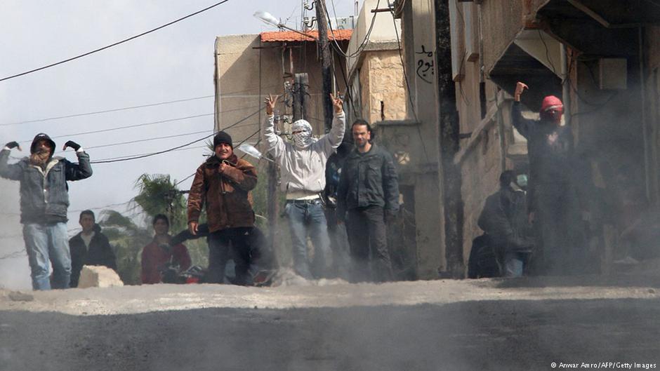 Anti-government protesters gesture on the streets of Daraa, 100 km south of the capital Damascus on 23 March 2011 (photo: Anwar Amro/AFP/Getty Images)