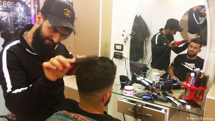 A barber at work in Derik, in Syria's northeast