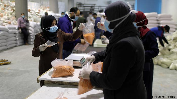 Workers pack food supplies to be distributed and delivered by the United Nations Relief and Works Agency (photo: Reuters/M. Salem)