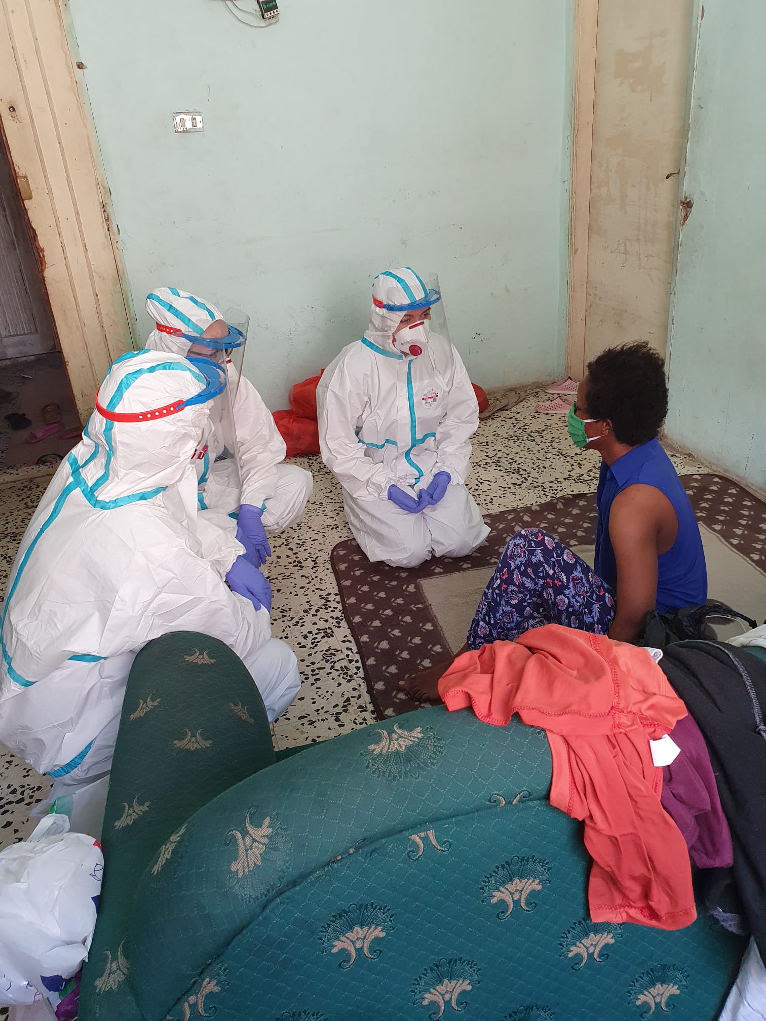 Doctors talk to Bukola in the apartment she shares with other Nigerian women (photo: Dara Foi'elle)