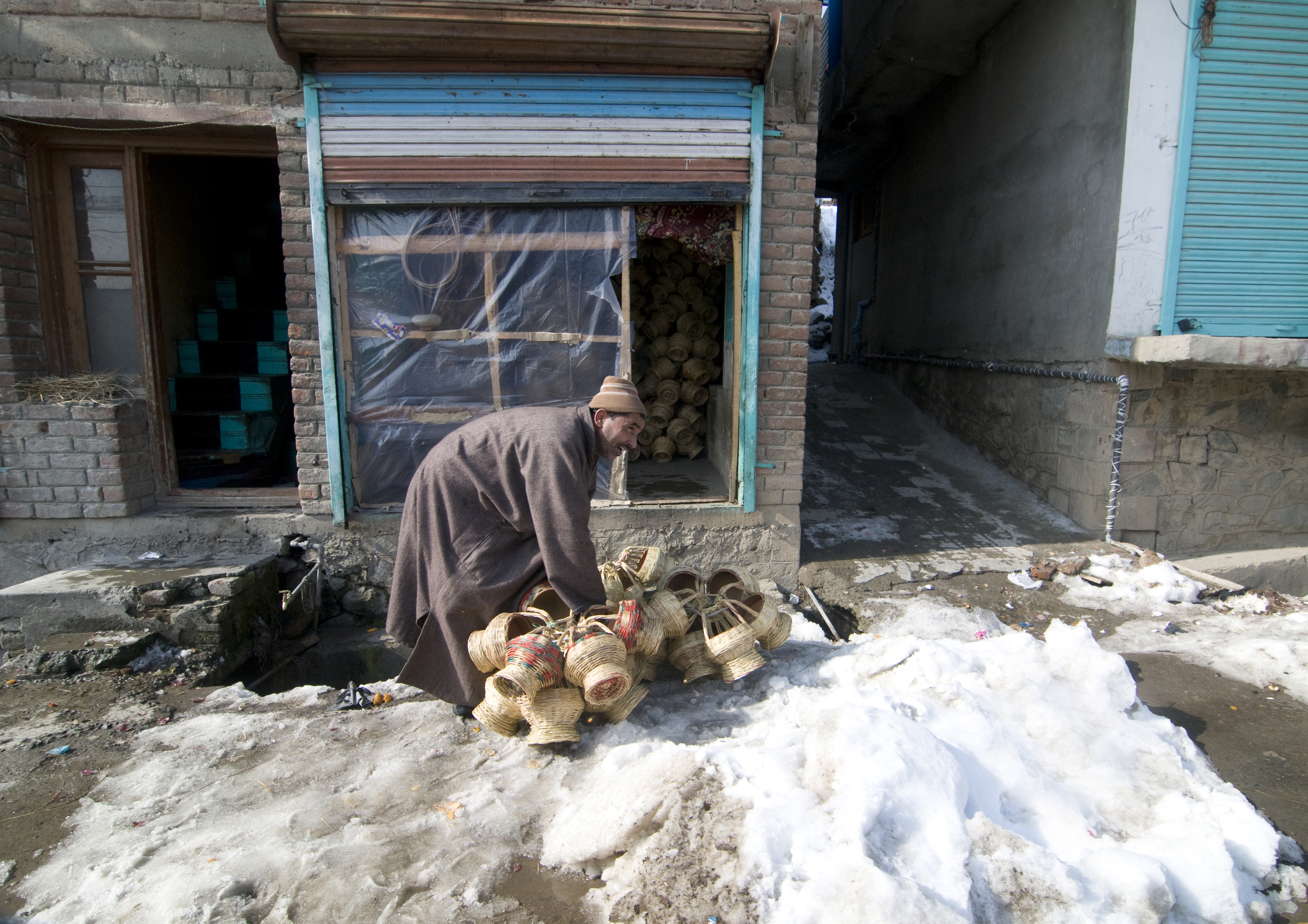 A kangdi vendor with his wares on a snowy backstreet in Srinagar (photo: Sugato Mukherjee)