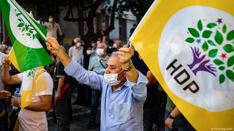 A man waving flags in support of the pro-Kurdish party HDP (photo: Yasin Akgul/AFP)