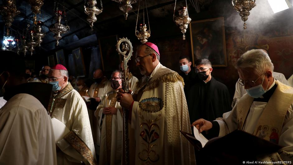 The Latin Patriarch of Jerusalem, Pierbattista Pizzaballa, leads a Christmas midnight mass at the Church of the Nativity in Bethlehem, the Israeli-occupied West Bank, 25 December 2020 (Abed Al Hashlamoun/Pool via REUTERS) 