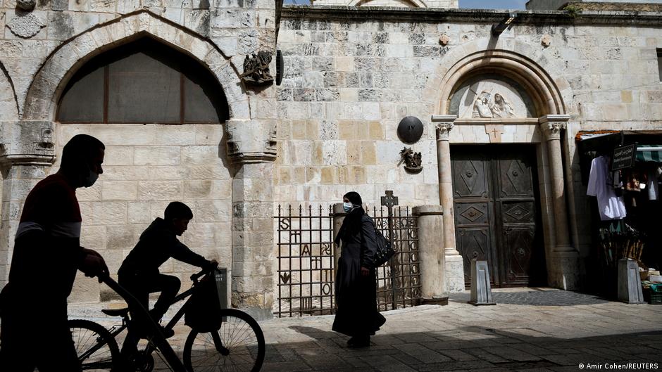 People pass two Stations of the Cross along the route of the Via Dolorosa in Jerusalem's Old City, 21 March 2021 (photo: Reuters/Amir Cohen)     