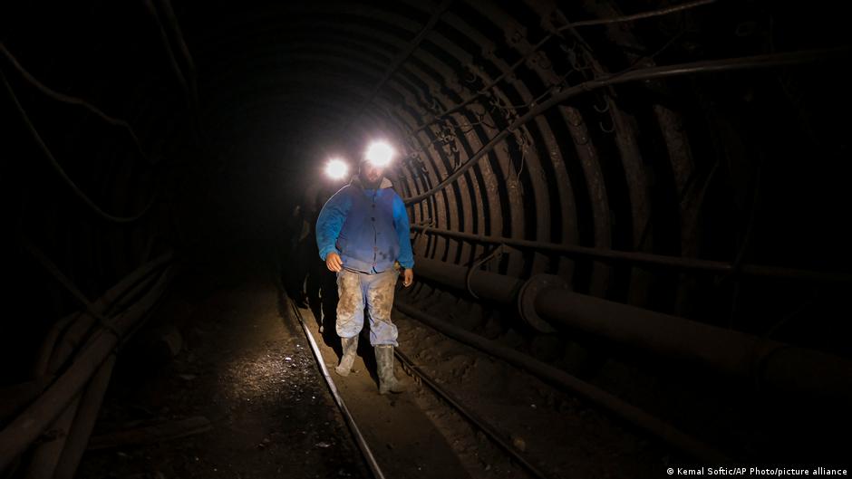 Bosnian coal miners walk in an underground tunnel at a mine in Zenica, Bosnia, 29 April 2021 (photo: AP Photo/Kemal Softic)