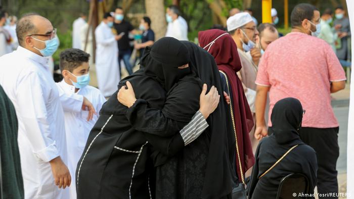 Two Saudi women hug after morning prayer