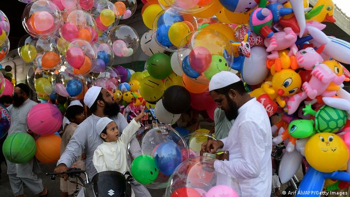 A child picks a balloon out of many in Karachi, Pakistan