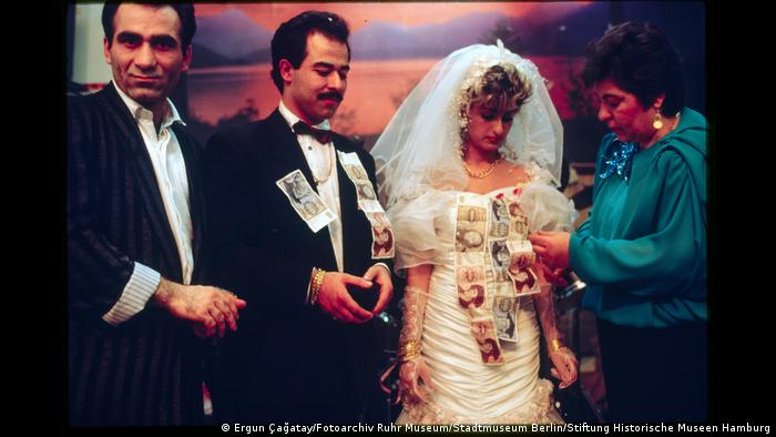 Bridal couple getting banknotes pinned on them