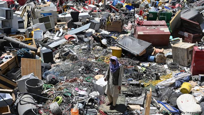 A man surrounded by scrap metal in Bagram