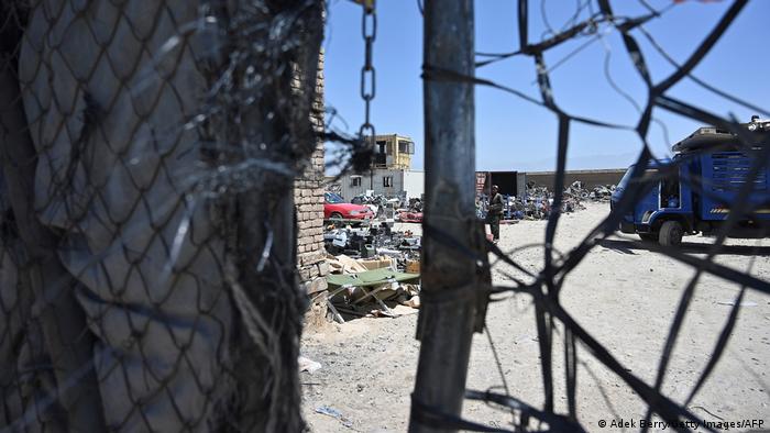 View through a barrier at Bagram scrap yard