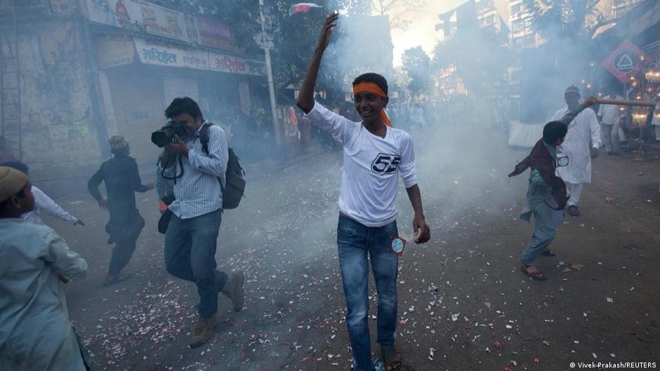 Reuters photographer Danish Siddiqui takes pictures as fireworks explode during a procession to mark Eid-e-Milad-ul-Nabi, birthday celebrations for the Prophet Muhammad, in Mumbai, India, 16 February 2011 (photo: REUTERS/Vivek Prakash)