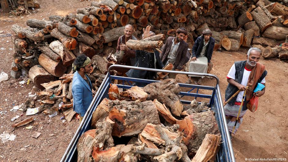 Vendors load wood onto a truck at a firewood market in Sanaa, Yemen, 17 July 2021 (photo: Reuters/Khaled Abdullah)