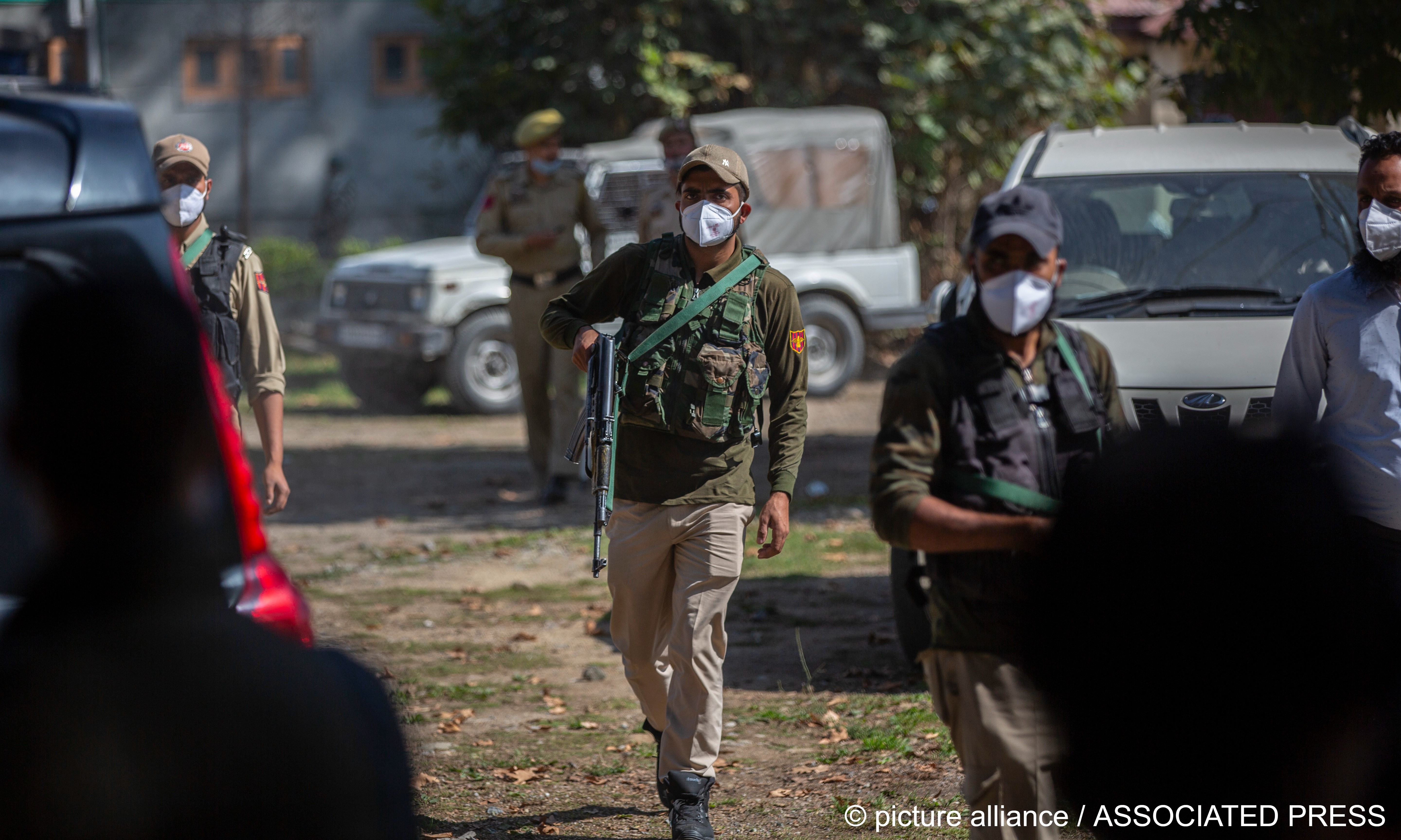 Indian policemen patrol during the funeral of Makhan Lal Bindroo, a prominent chemist from Hindu community in Srinagar, Indian controlled Kashmir on 6 October 2021 (photo: AP Photo/Mukhtar Khan)