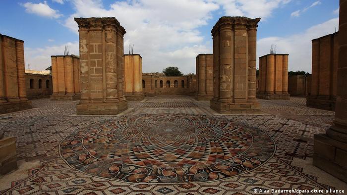 An intricate floor mosaic flanked by columns and open to the sky