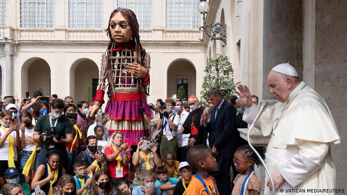 Little Amal receives a blessing from the Pope along with a group of children and teenagers (photo: Vatican Media Handout via Reuters)